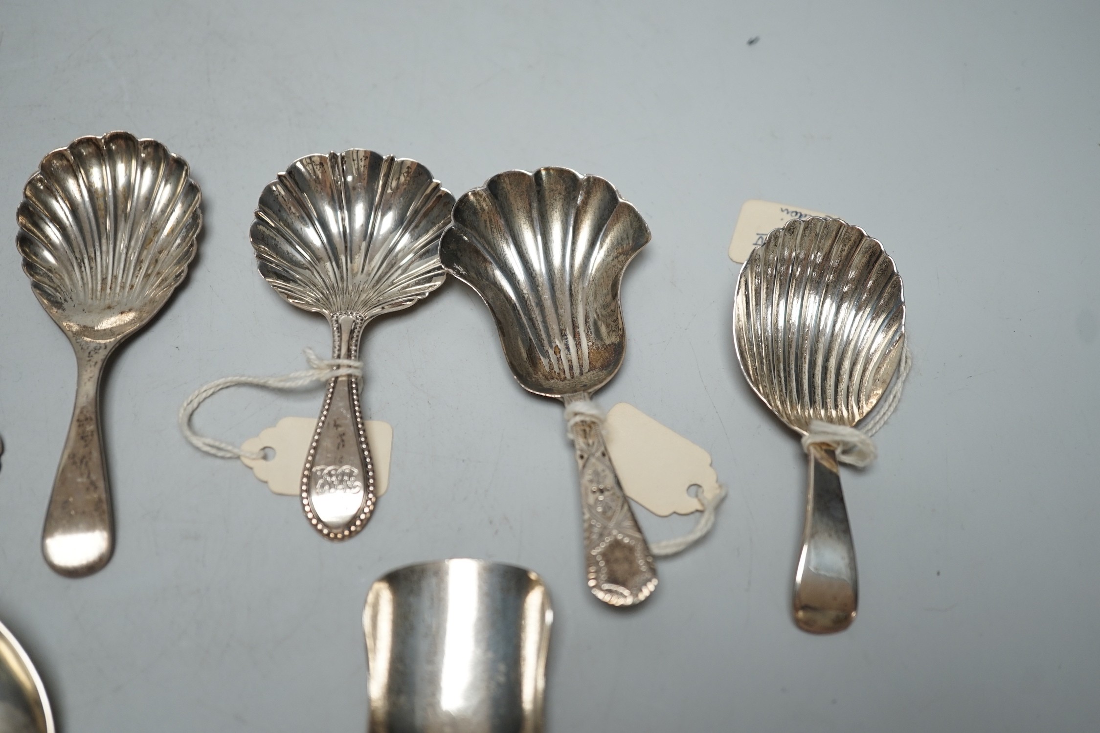 Three assorted 19th century silver caddy spoons, including London, 1829, three 20th century silver caddy spoons and two other silver spoons including Victorian sifter spoon, 14.7cm.